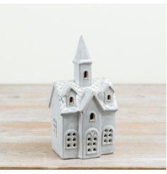 Ceramic decorative church featuring window cut-outs and a built-in LED light to create a soft illuminated effect.