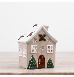 Festive candle house ornament with a charming Christmas design.
