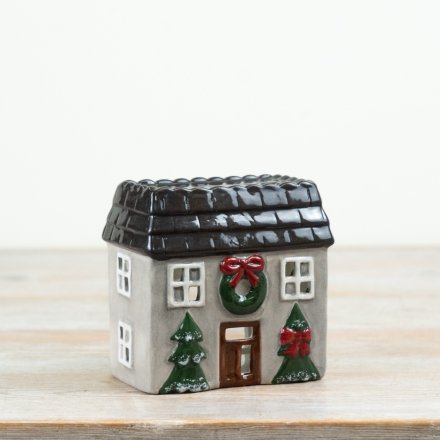 A delightful candle holder shaped like a cozy house.