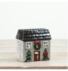 A delightful candle holder shaped like a cozy house.