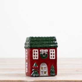 A delightful candle house in festive red and green hues.