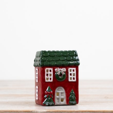 A delightful candle house in festive red and green colors.