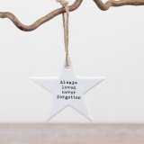 A beautiful white ceramic star hanger inscribed with “Always loved, never forgotten,” slogan