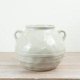Add timeless farmhouse charm to your collection with this neutral ceramic storage vase.