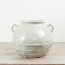 Crafted in a soft neutral glaze with subtle speckled detailing, this rounded vessel features two small side handles