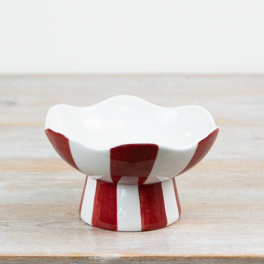 Bring holiday joy to your home with our festive Red & White Striped Candy Bowl.