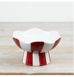 Bring holiday joy to your space with our red and white striped candy bowl.