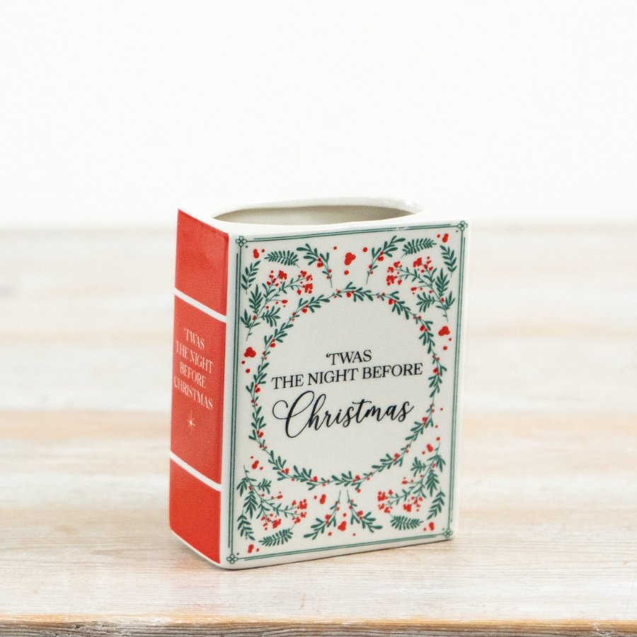 This ceramic book-style vase combines clean form with nostalgic seasonal illustration