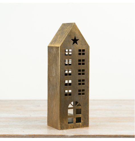 A tall metal house lantern finished in brushed gold with decorative star and window cut-outs.
