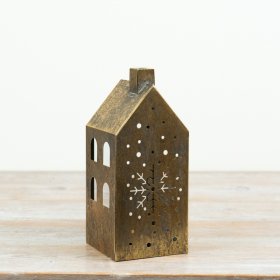 Add a warm, atmospheric glow to festive interiors with this antique gold house candle holder