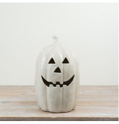 Crafted in a soft neutral glaze, this modern jack-o'-lantern adds a stylish festive touch to any space.