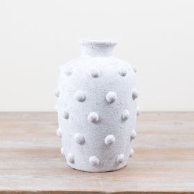 A delightful cement vase with a playful bobble design.