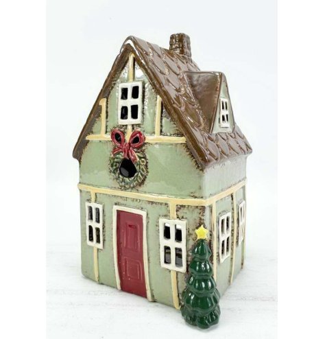 A delightful green candle house with a vintage shabby chic style.
