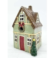 Cute green shabby chic candle house with charming vintage style.
