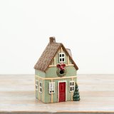 A delightful green candle house with a vintage shabby chic style.