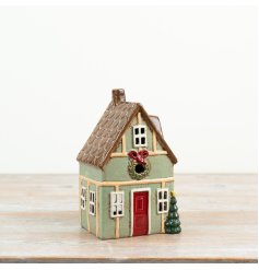 Cute green shabby chic candle house with charming vintage style.