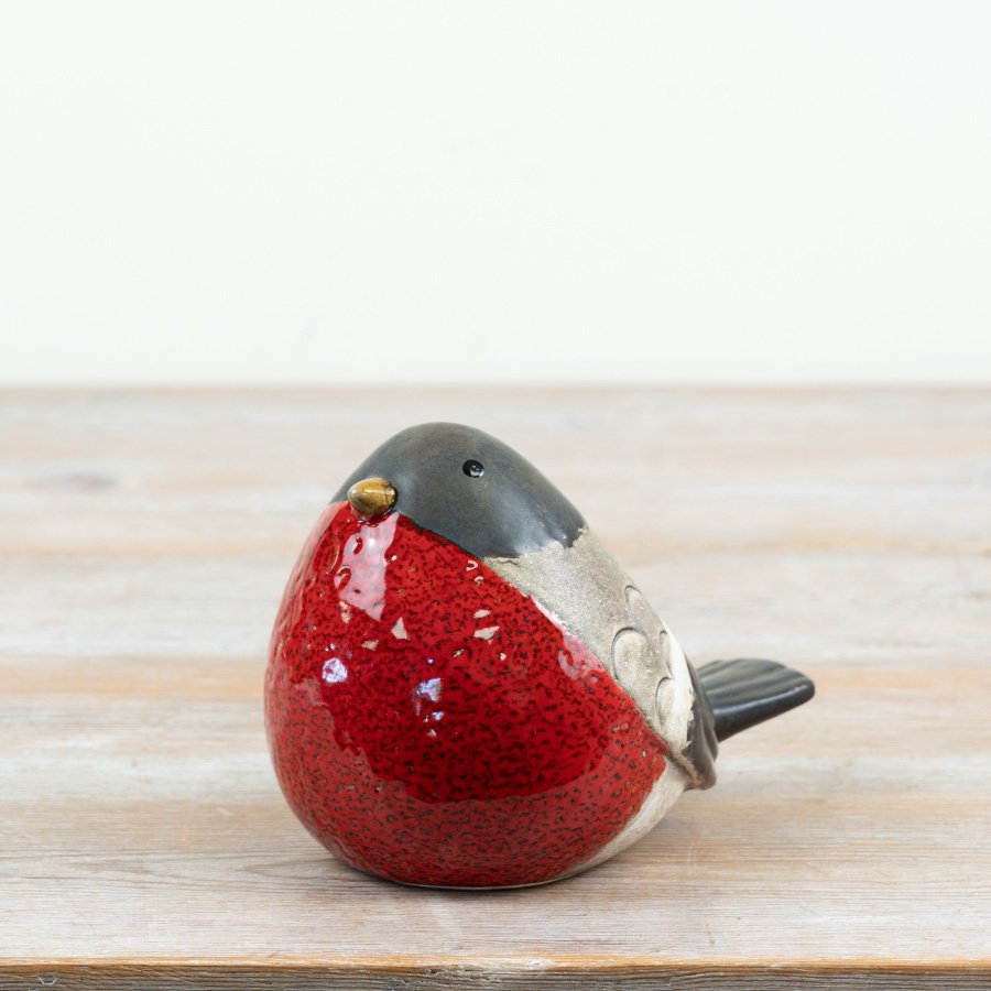 a delightful robin decoration with rustic black and red glaze