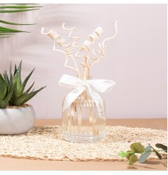 a charming Pomegranate Noir diffuser complete with bow 