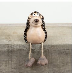 Bring a touch of woodland charm to your décor with this delightful hedgehog featuring playful dangling legs