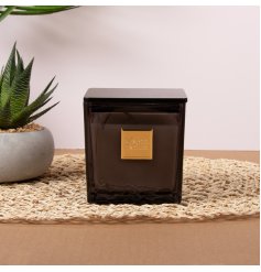 Charming square-shaped scented wax candle with delightful fragrance.