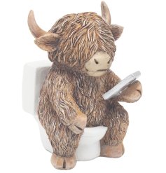 Bring humor home with this quirky Highland Cow on a toilet