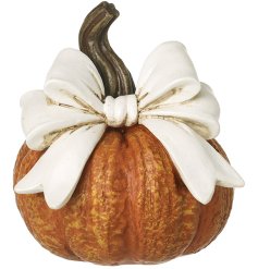 Bring cozy autumn vibes to your space with this charming pumpkin décor piece.