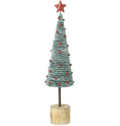 Celebrate with this large tree, adorned with bright red berries and a delightful star on top.