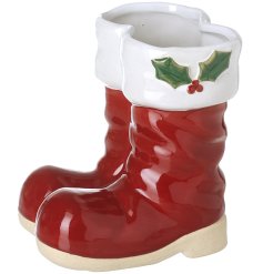 Bring holiday cheer with delightful ceramic Santa boots décor.