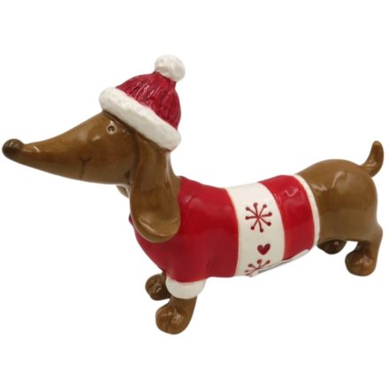 Charming ceramic sausage dog dressed for Christmas with heart and snowflake motifs