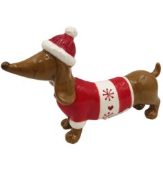 Charming ceramic sausage dog dressed for Christmas with heart and snowflake motifs