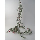 Lush green garland adorned with festive red berries and natural pinecones for timeless charm