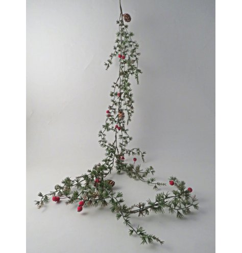 Rich green garland decorated with natural pinecones and bright red berries for enduring festive style
