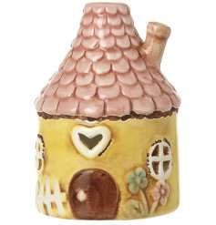 Add warmth to your space with this sunny Yellow Ceramic Round House Ornament.