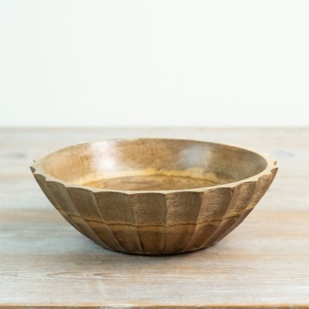 Add rustic charm to your home with this handcrafted carved mango wood bowl showcasing natural texture.