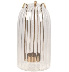 Infuse your room with the gentle shimmer of this elegant gold-accented glass lantern