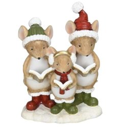 Delightful mice in seasonal hats and boots gathered around a book for festive warmth