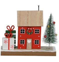 Celebrate the holidays with this delightful wooden house ornament.
