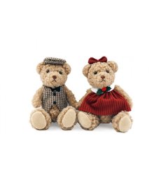 This charming 10cm sitting bear, dressed in a vibrant red festive dress with a checked waistcoat and hat