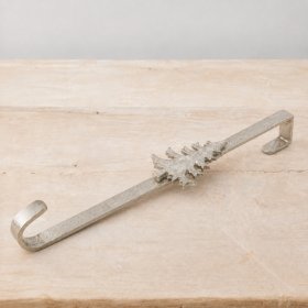 Chic aluminium wreath hanger in raw nickel finish adds rustic festive elegance