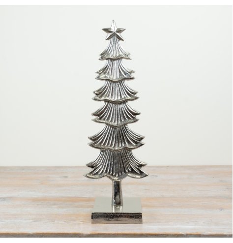 Elegant silver tree featuring a star and intricate patterns.
