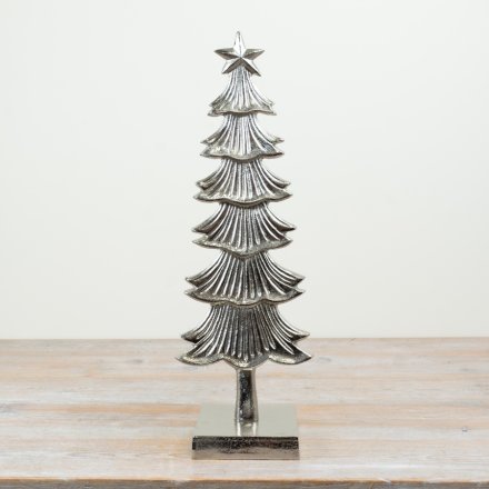 A charming silver patterned tree with star 