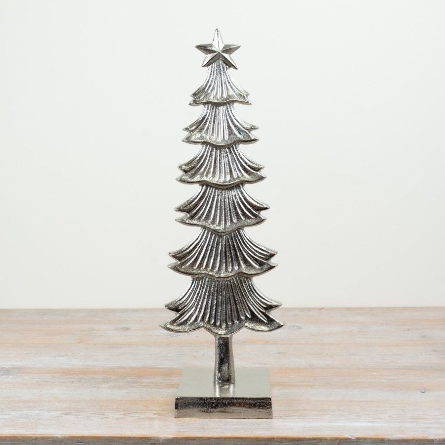 Elegant silver tree adorned with a star and intricate patterns.