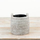 a charming natural planter with handles for easy moving 