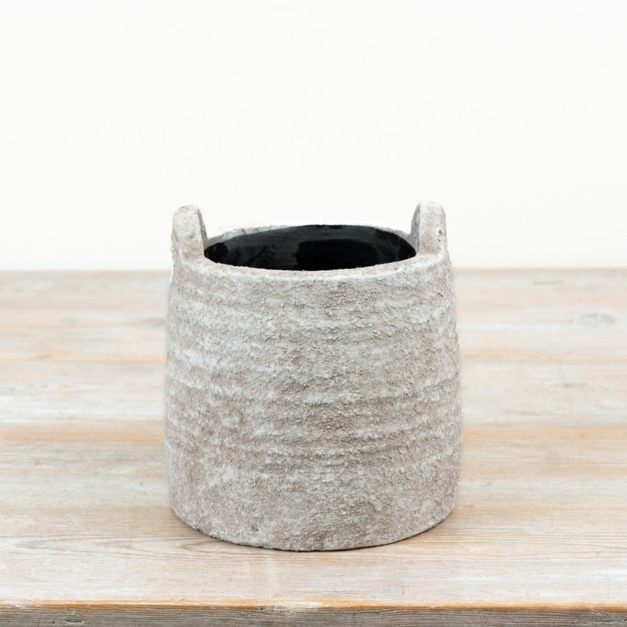 A delightful natural planter featuring convenient handles for effortless relocation