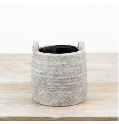 a charming natural planter with handles for easy moving 