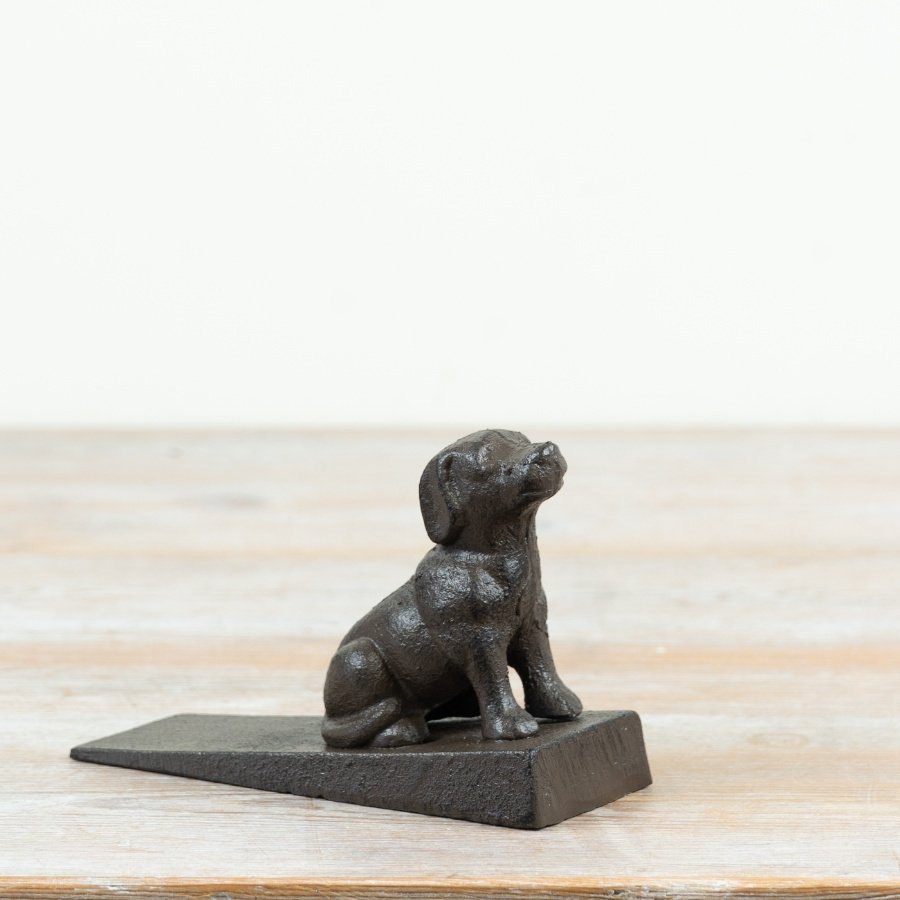 Endearing and durable cast iron door stop in a rustic dog design with a natural finish