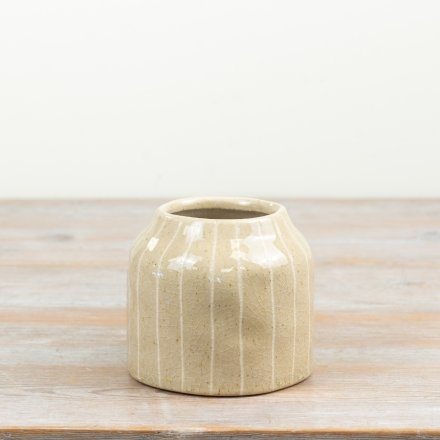 a small glossy lined ceramic vase 
