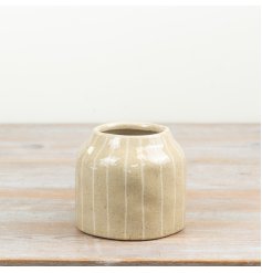 a small glossy lined ceramic vase 