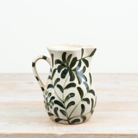 an elegant jug vase with a glossy cream glaze and leaf detailing