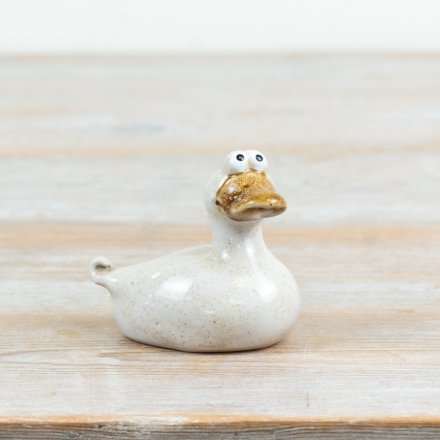Charming hand-crafted ceramic duck with playful wide-eyed charm